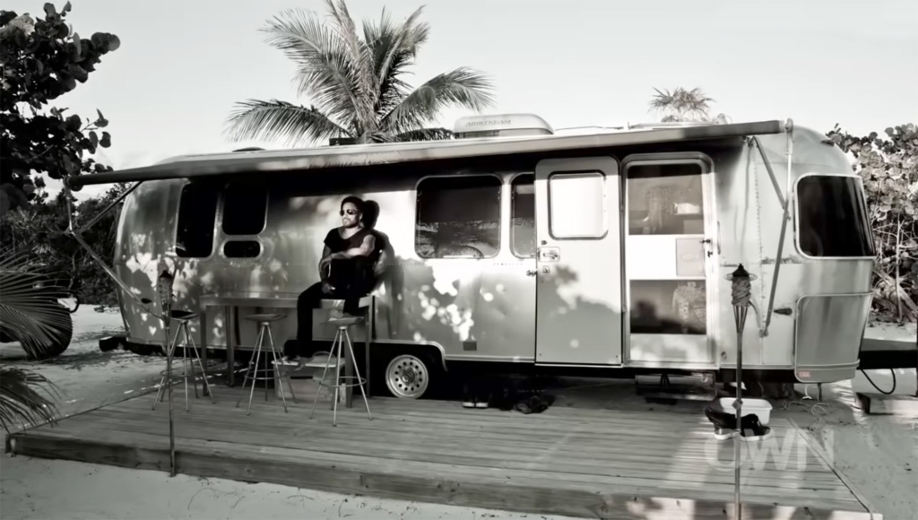 Lenny Kravitz outside his silver Airstream trailer in the Bahamas in 2013.