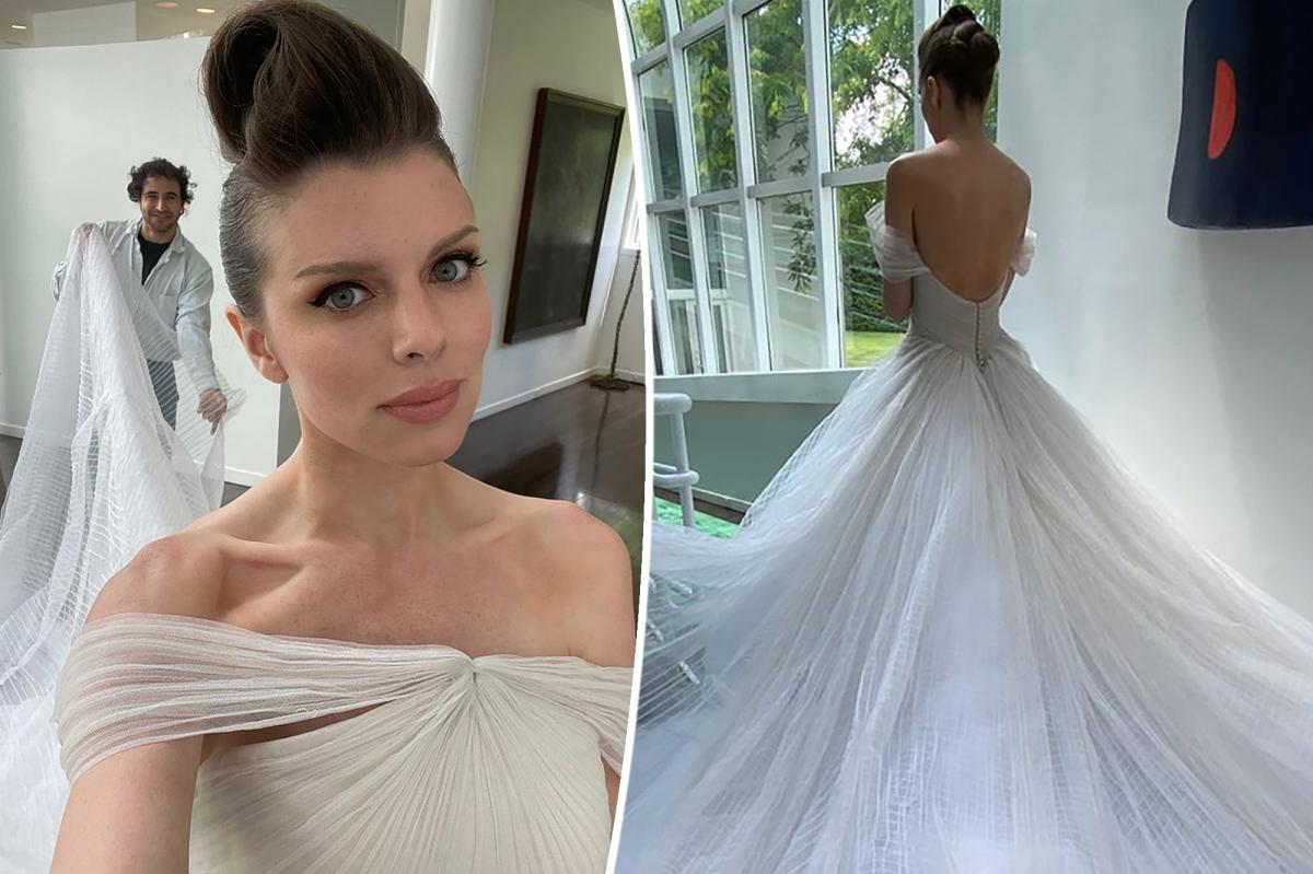 Julia Fox twirling in a wedding dress
