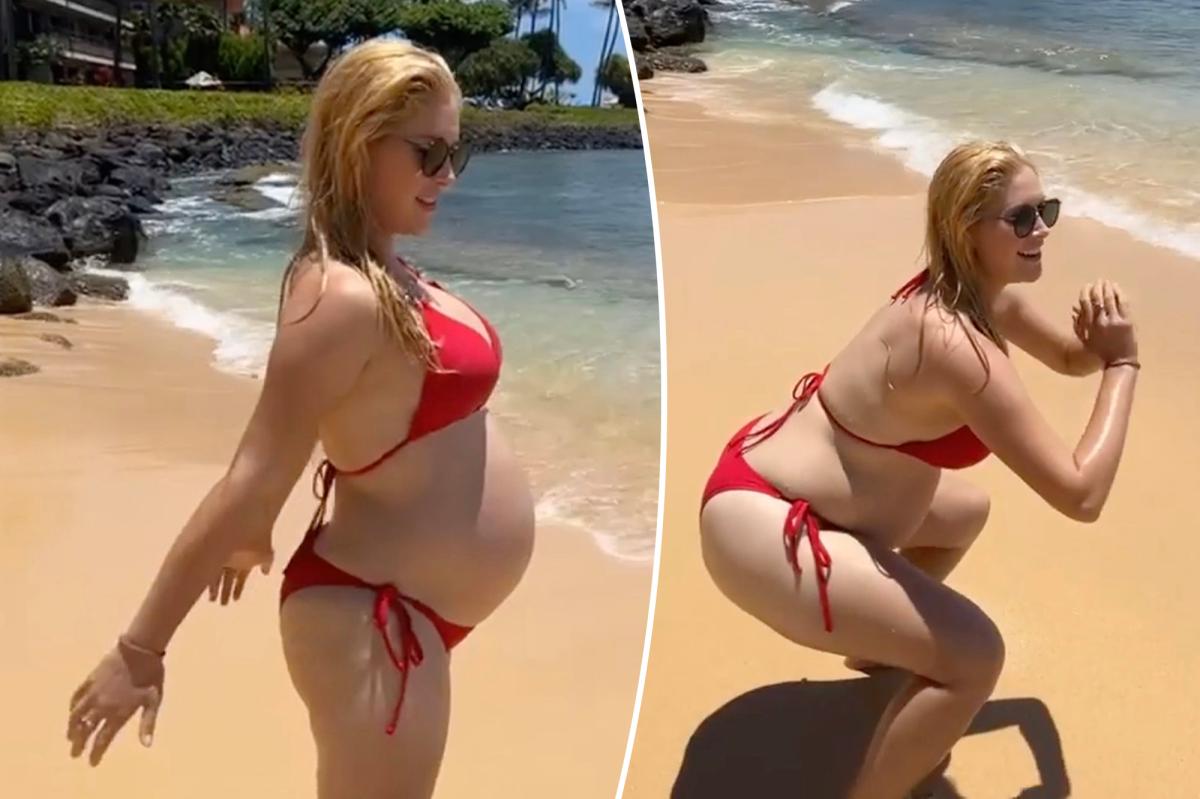 Pregnant Heidi Montag works on the beach in a smoking hot bikini