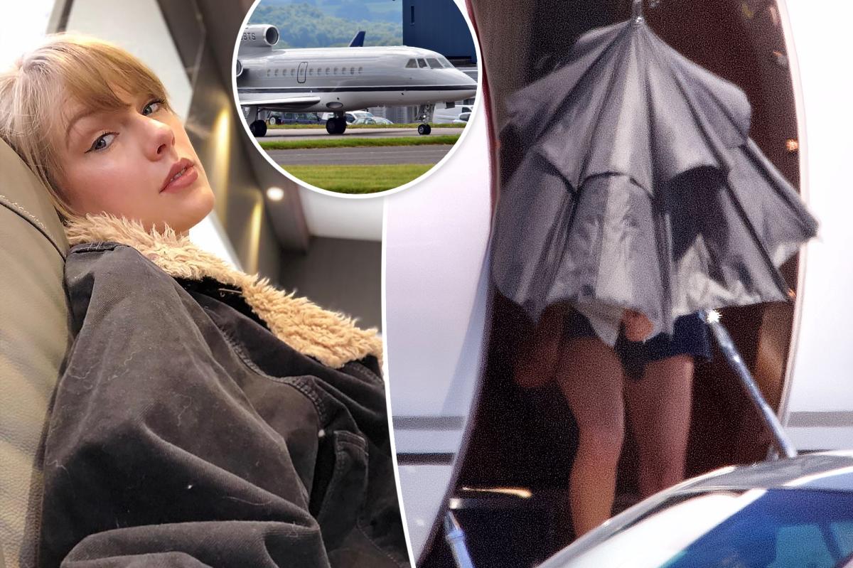 Taylor Swift hides behind umbrella as she gets off private jet