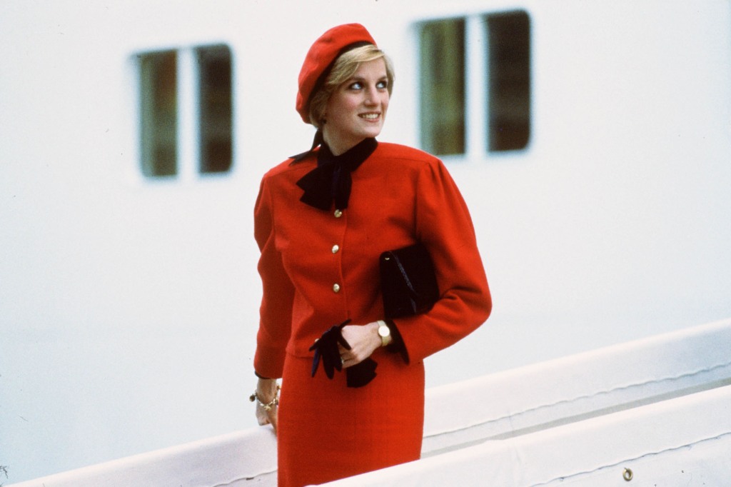 Diana, Princess of Wales, wears a red suit and beret as she disembarks. 