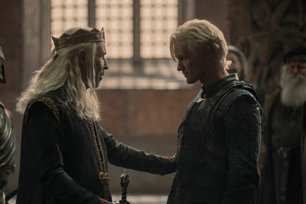 King Viserys (Paddy Consideine) and his younger brother Daemon (Matt Smith) smile at each other. 