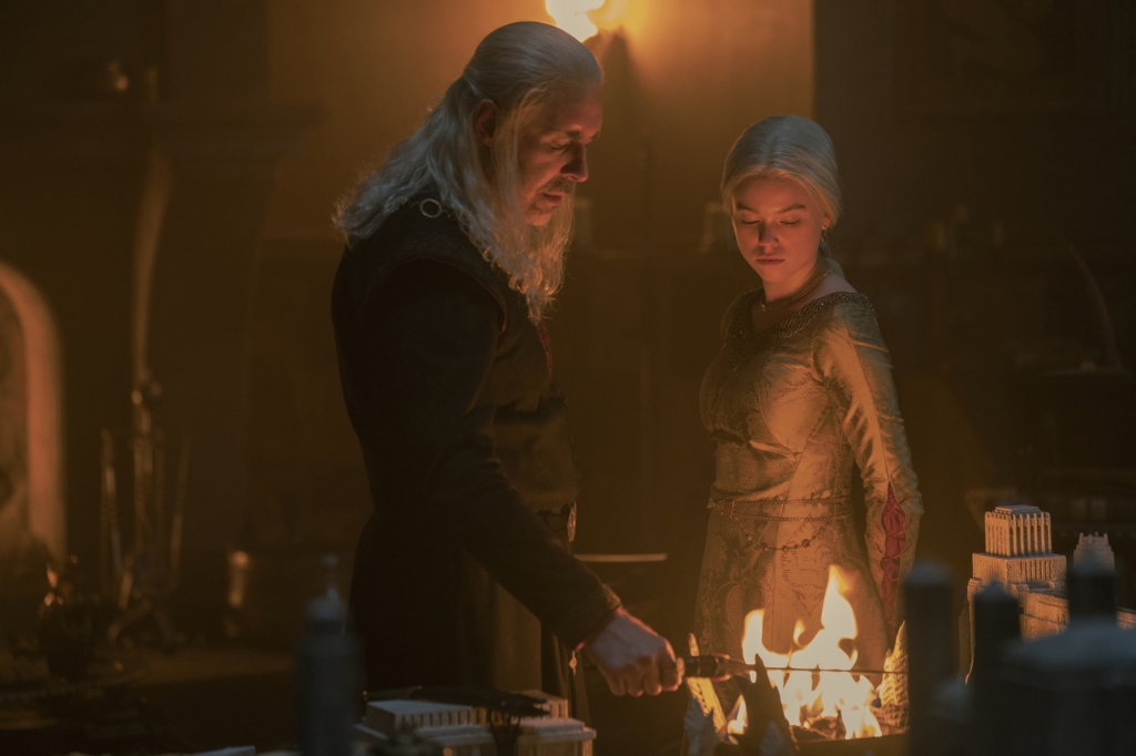 Rhaenyra (Milly Alcock), right, with her father King Viserys (Paddy Considine) looking at fire. 